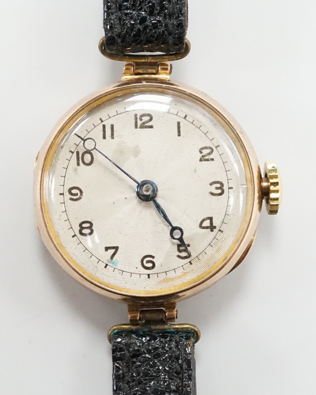 An early 20th century 9ct gold Rolex manual wind wrist watch, with Arabic dial, case diameter 27mm, on associated leather strap.